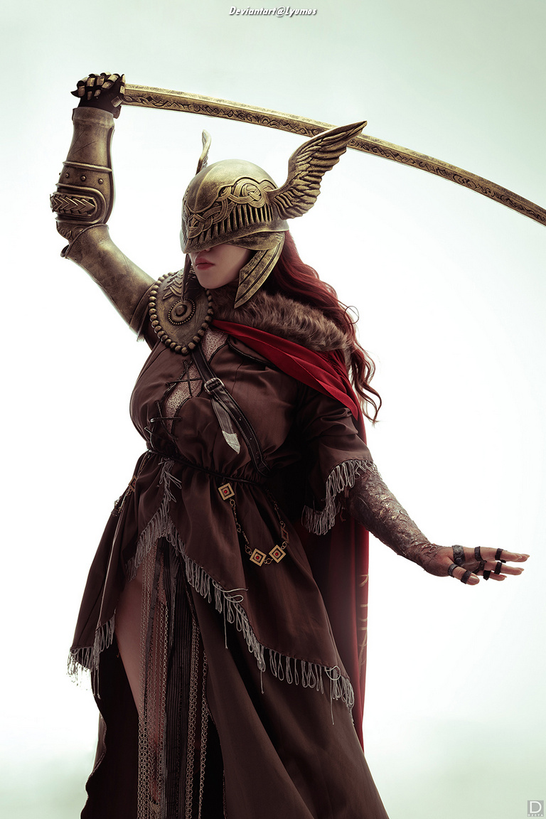A warrior woman in an ornate helmet and cloak, wielding a sword, stands in a powerful pose against a light background.