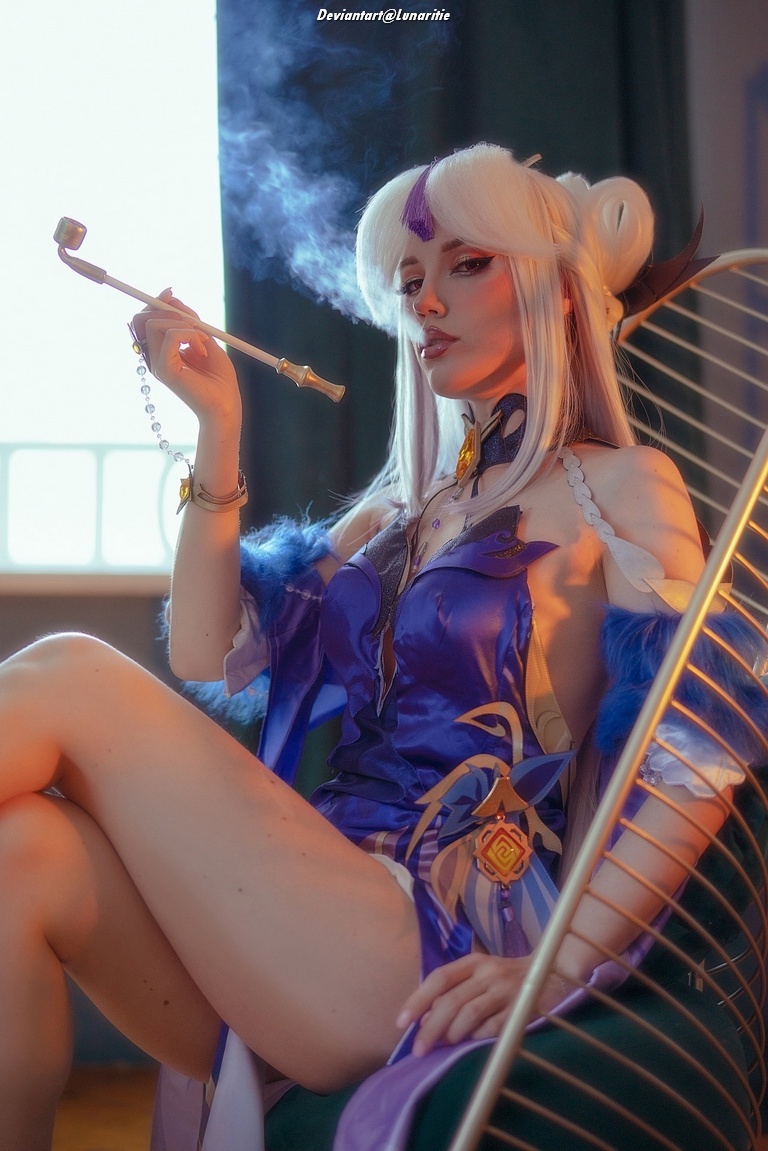 A character in an elaborate purple costume sitting elegantly, holding a smoking pipe, with a dreamy expression and long white hair. The background features soft lighting and muted colors.