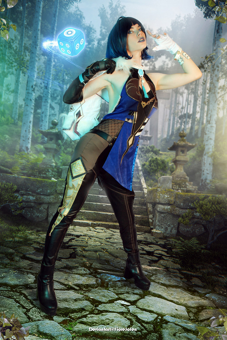 A person in an elaborate costume with blue and black colors striking a dynamic pose in a lush forest setting with stone steps and traditional elements.