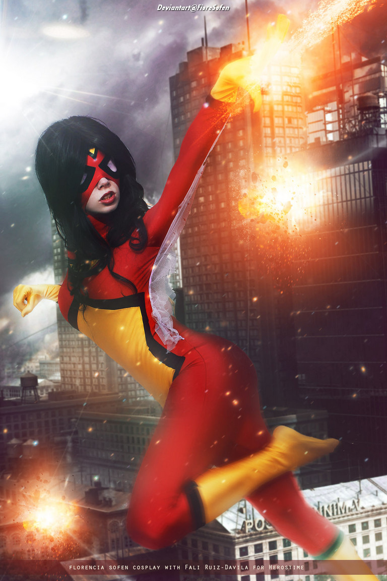 Cosplayer dressed as a superhero in a red and yellow costume, striking a dynamic pose with a cityscape in the background and special effects of flames.