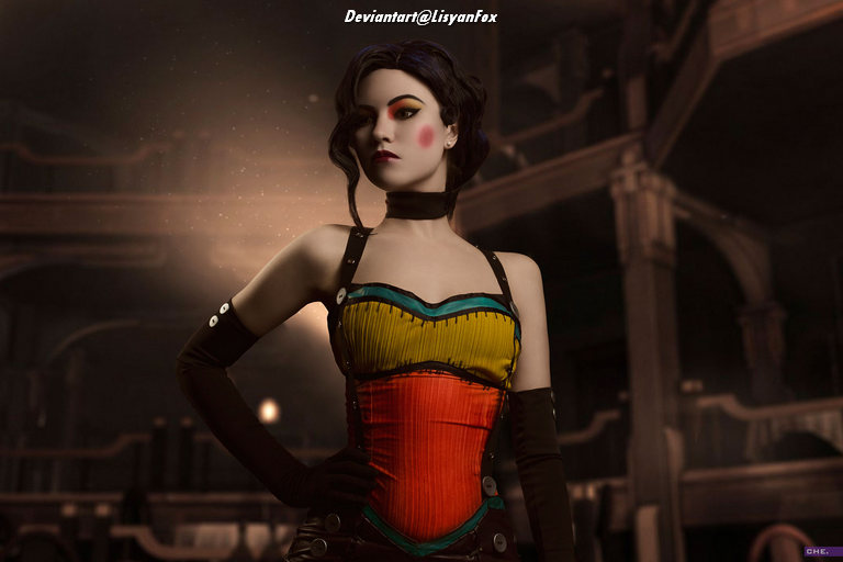 A stylish woman posing confidently in a colorful corset in a vintage setting with warm lighting.