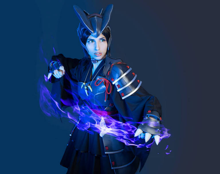 A person dressed in a dark samurai-inspired costume with a helmet, holding a glowing purple effect in one hand against a blue background.