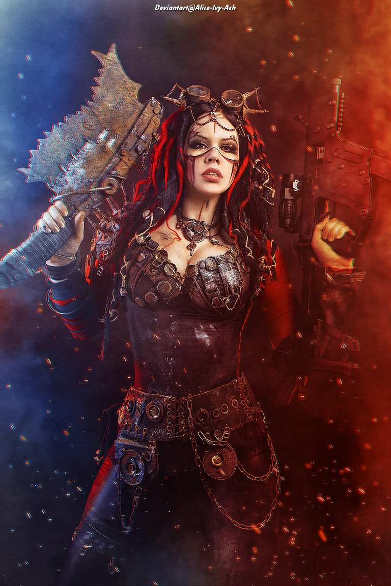 A woman in a steampunk-inspired outfit holds a chainsaw and a futuristic gun, with a fierce expression. She's adorned with goggles and has brightly colored hair, set against a dramatic, smoky background.