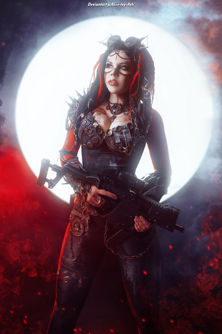 A woman in a gothic costume with red hair and dark makeup stands confidently holding a gun, with a glowing full moon in the background surrounded by red smoke.