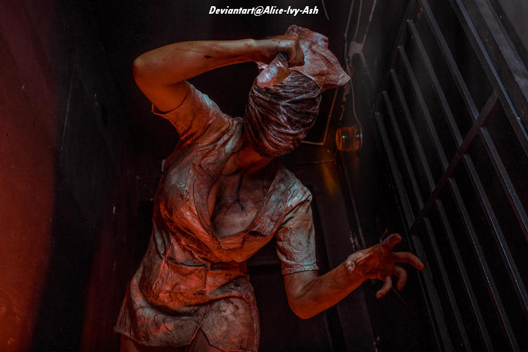 A creepy nurse figure with a blood-stained uniform, holding her head as if in distress, set against a dark, ominous background.