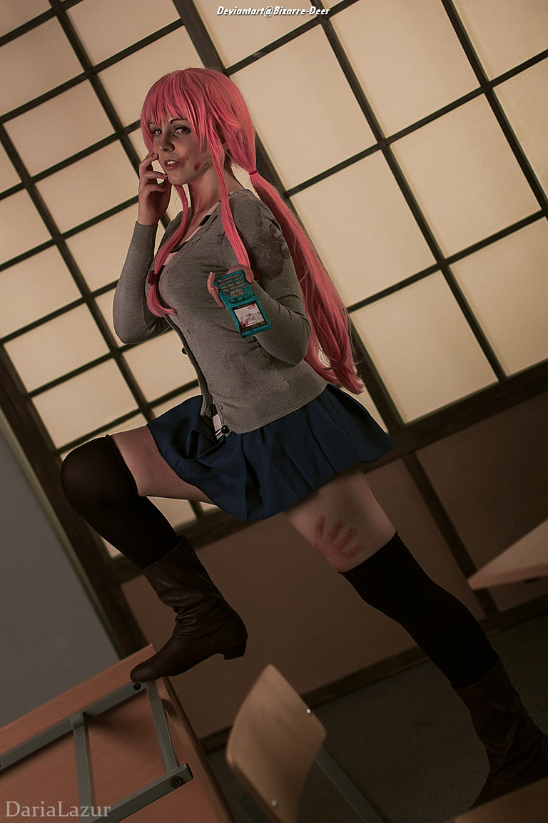 A person wearing a pink wig and a school uniform is standing on a desk, holding a phone to their ear. The individual has a few smudges and scratches on their skin, with a distressed expression, set against an interior with shoji screens.