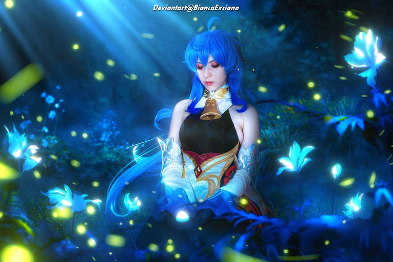 A person with long blue hair sits serenely in a mystical forest, surrounded by glowing flowers and soft light rays.