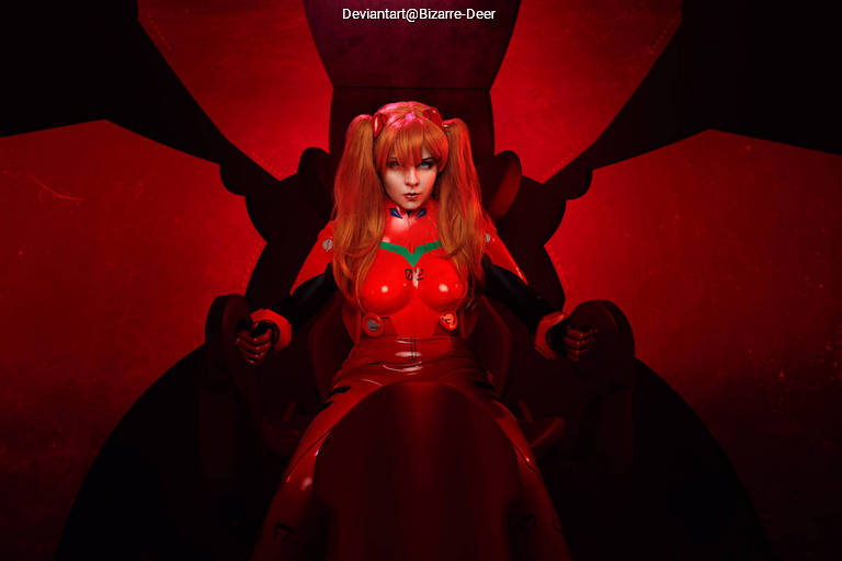 A character with long orange hair styled in pigtails, wearing a red suit, sits in a large black chair in a dramatic red-lit environment.