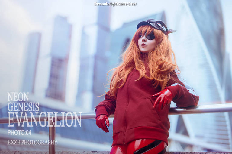 A person in a red and black outfit with long orange hair and sunglasses, posing in an urban setting, inspired by the character from Neon Genesis Evangelion.