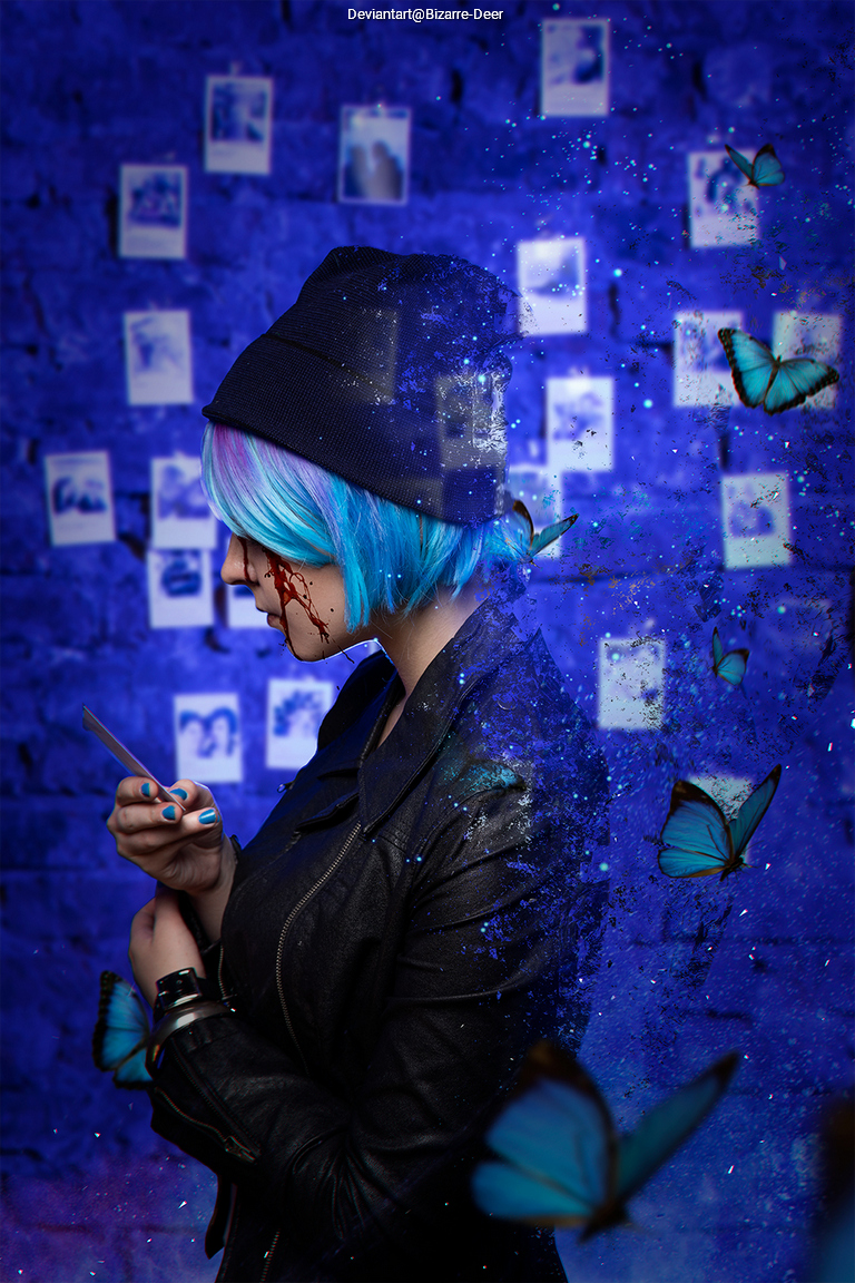 A person with short, blue and purple hair wearing a black beanie and leather jacket, holding a knife. They stand against a blue brick wall with scattered photographs and butterflies floating around them.