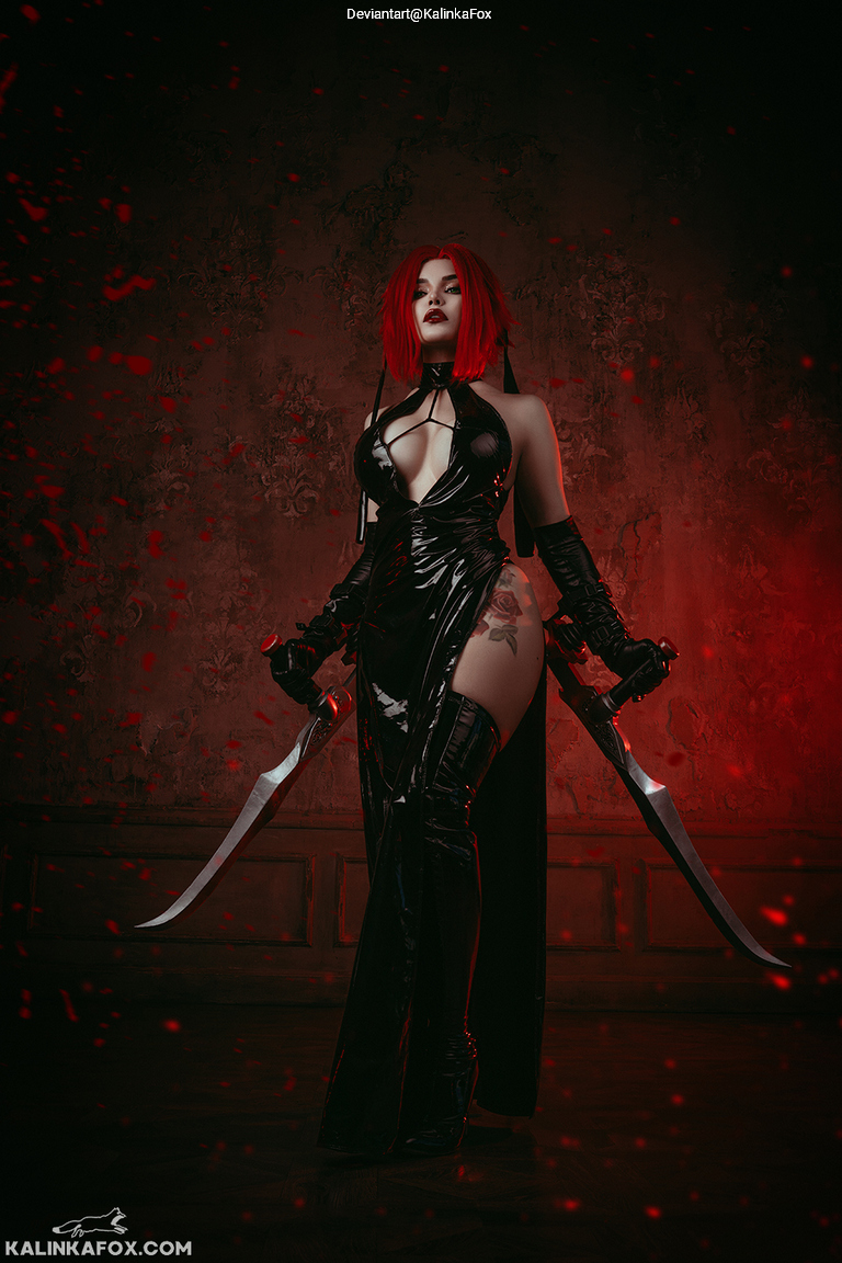 A woman with red hair wears a black latex outfit and holds two curved swords. The background is dark with red accents.