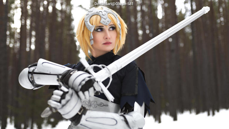 A person in a fantasy costume holding a sword, set in a snowy forest with tall trees in the background.