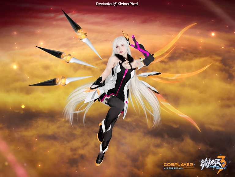 A cosplayer dressed as a character with long white hair and a black and pink outfit, surrounded by large, sharp, wing-like structures, set against a dramatic background of clouds.