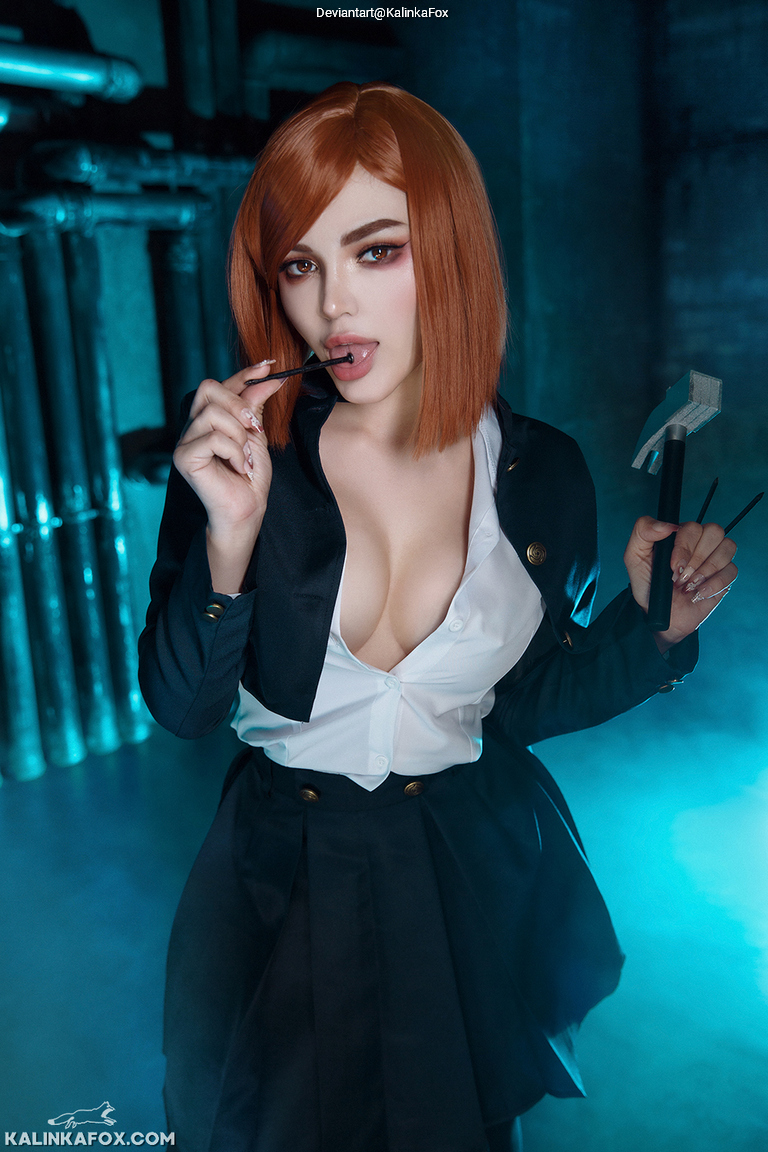 A woman with short brown hair wearing a partially unbuttoned shirt and a dark skirt, holding a tool and posing confidently in a moody, blue-lit environment.
