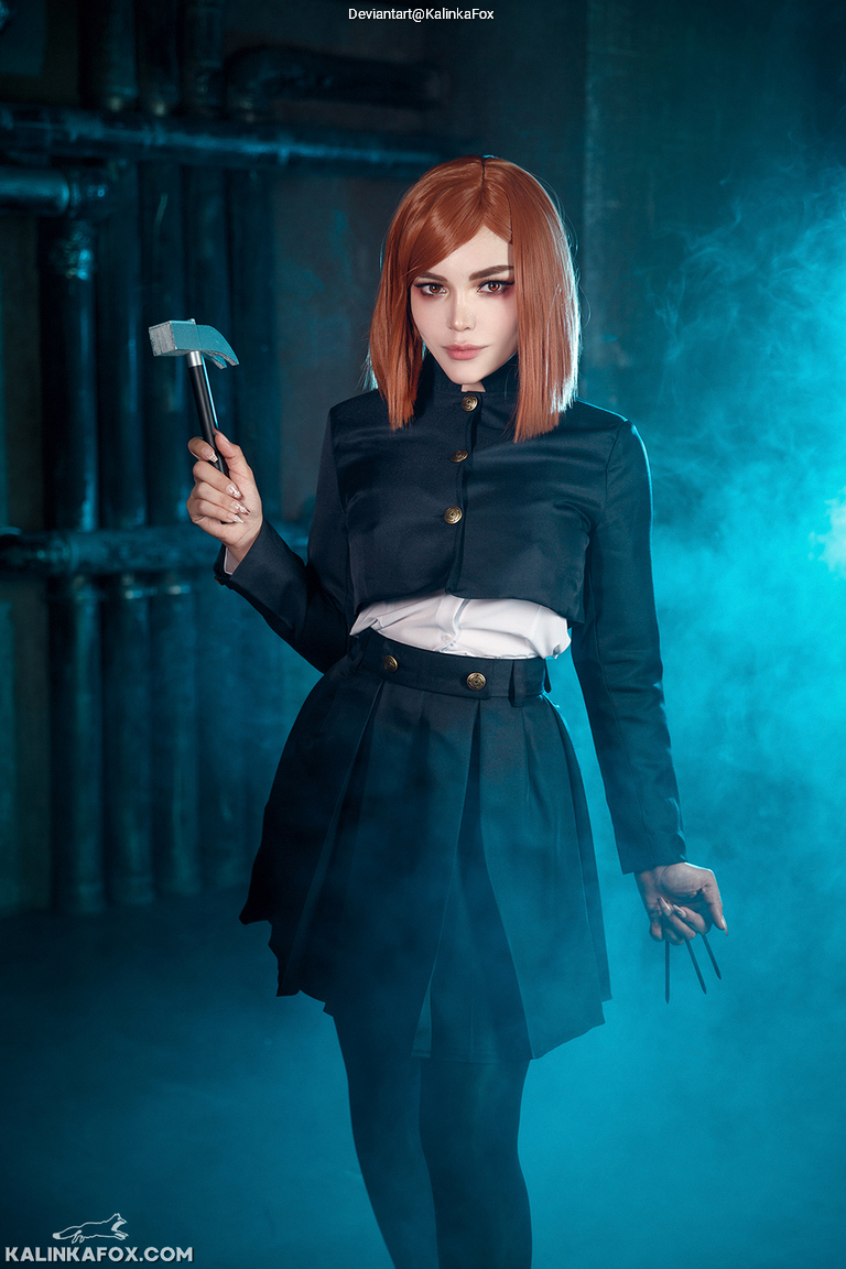 A person in a black outfit with a white shirt, holding a small hammer in one hand and three thin tools in the other, standing in a misty environment with blue lighting.