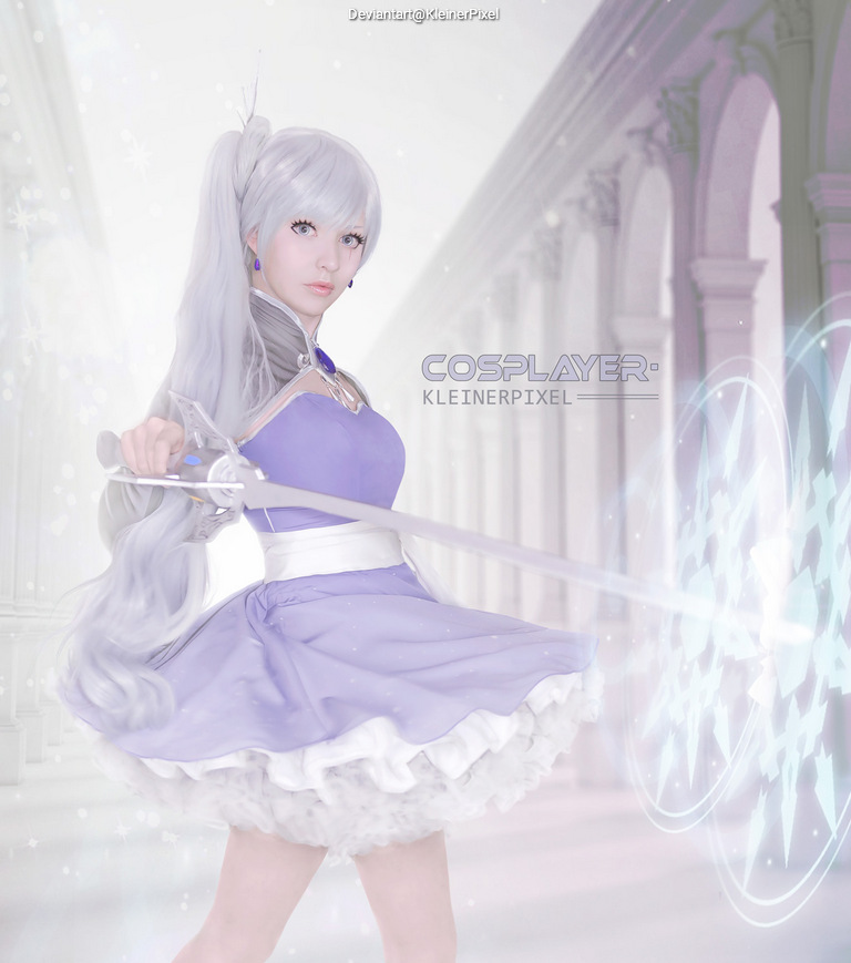 A female cosplayer with long silver hair wearing a purple dress, wielding a sword in an elegant pose, set against a softly lit, ethereal background.