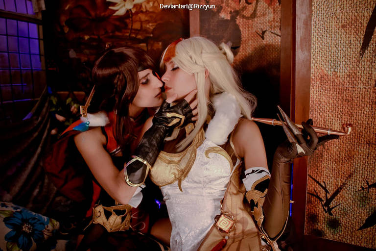 Two individuals in elaborate costumes are leaning in for a kiss, set against a richly decorated backdrop.