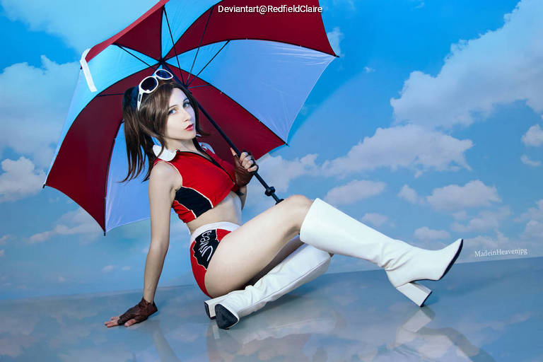 A person dressed in a red and black outfit with an umbrella, posing against a blue sky backdrop with clouds.