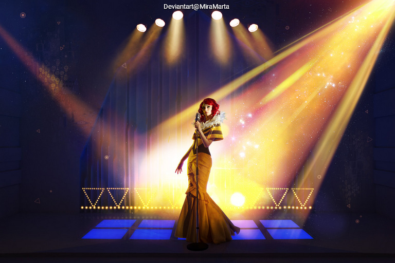 A glamorous woman in a shimmering gold dress stands confidently on stage under bright spotlight beams, with colorful lights creating a vibrant atmosphere.