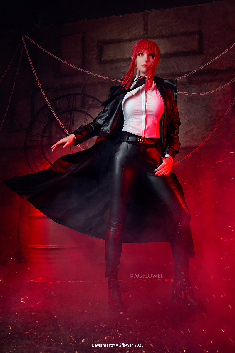 A female figure with red hair, dressed in a black leather outfit and a long coat, striking a confident pose against a dramatic, foggy background with red lighting.