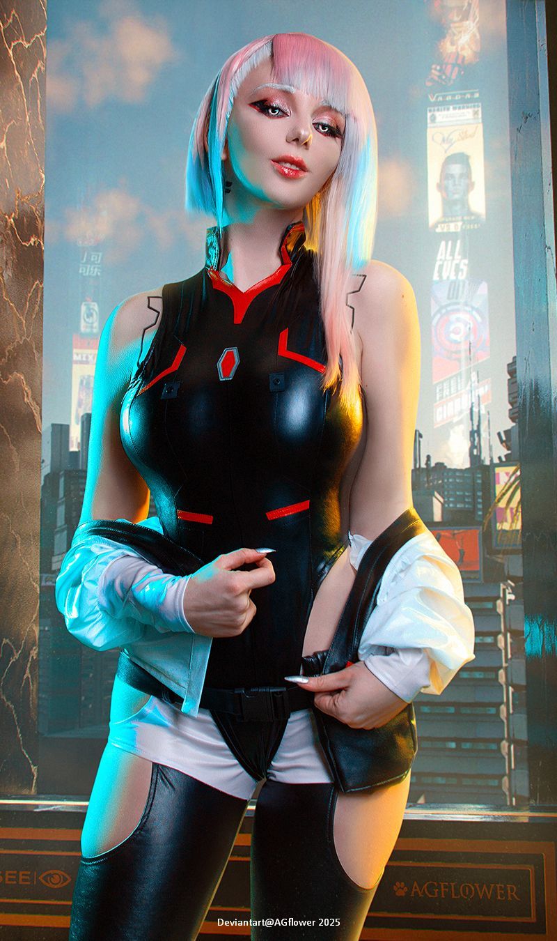 A person dressed in a futuristic, form-fitting outfit with a high collar and accents, standing in front of a cityscape background featuring bright signs and advertisements.