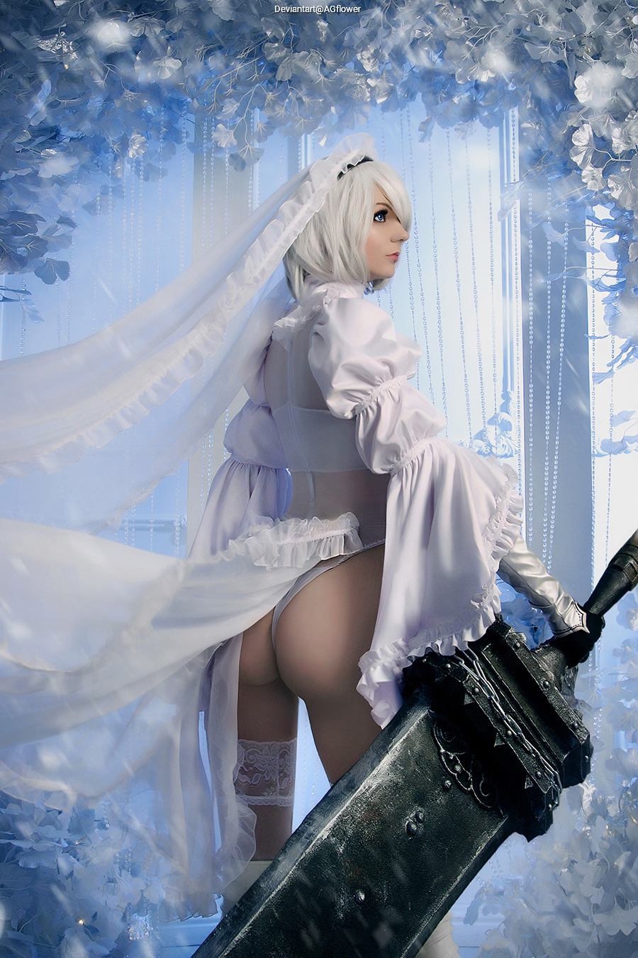 A character in a white dress with a veil, holding a large sword, posed against a backdrop of blue and white flowers.