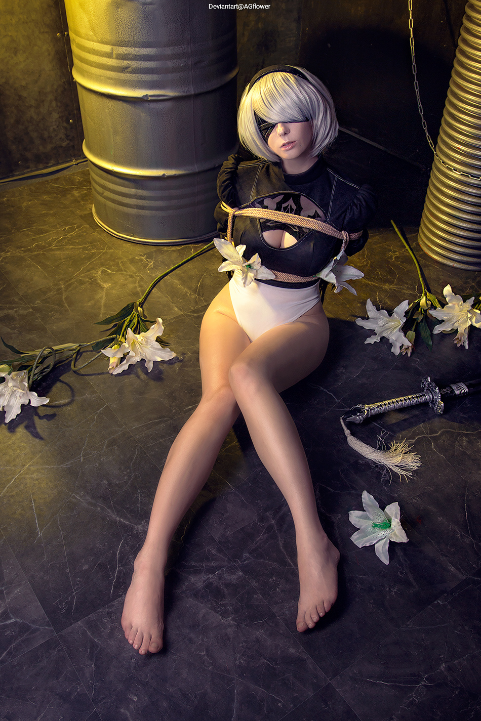 A character with short white hair and an eye patch sits surrounded by white lilies, restrained with ropes, in a dark industrial setting.