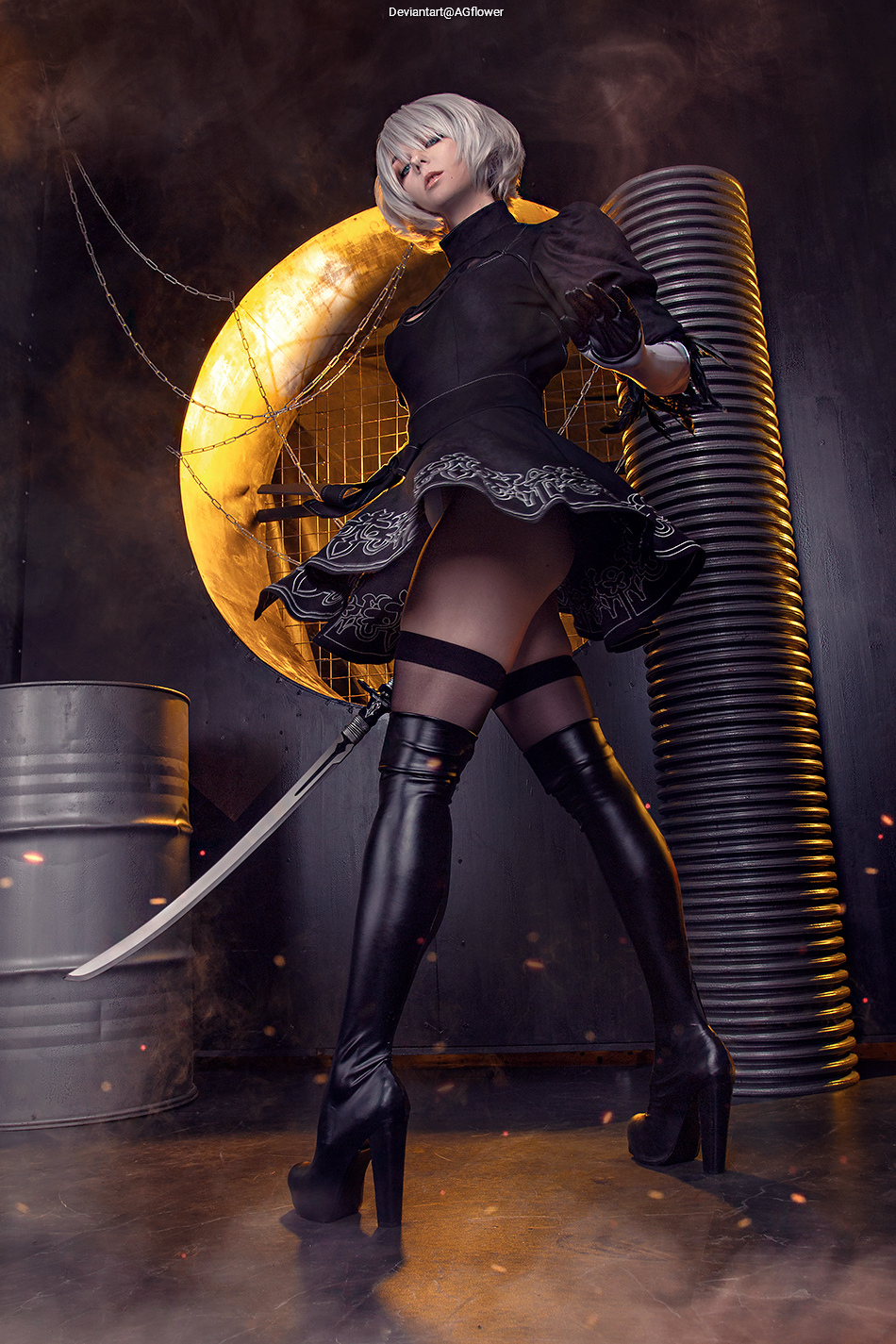 A character in a black outfit with a short skirt and high boots, holding a sword, posed dramatically against a backdrop featuring industrial elements and a glowing circular structure.