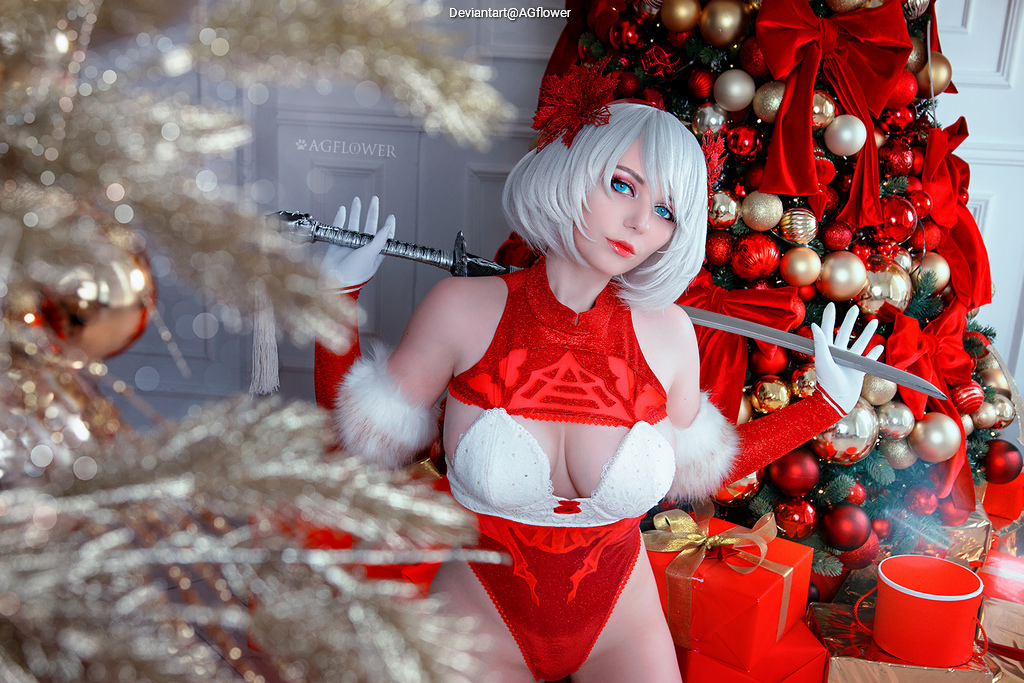 A character in a festive red and white outfit poses with a sword in front of a decorated Christmas tree and presents.