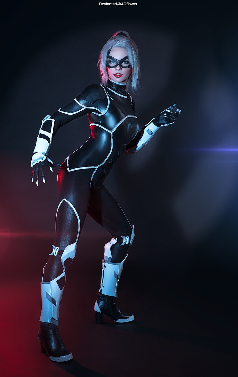 Female superhero in a black and white bodysuit striking a dynamic pose against a dark background with purple and red lighting.